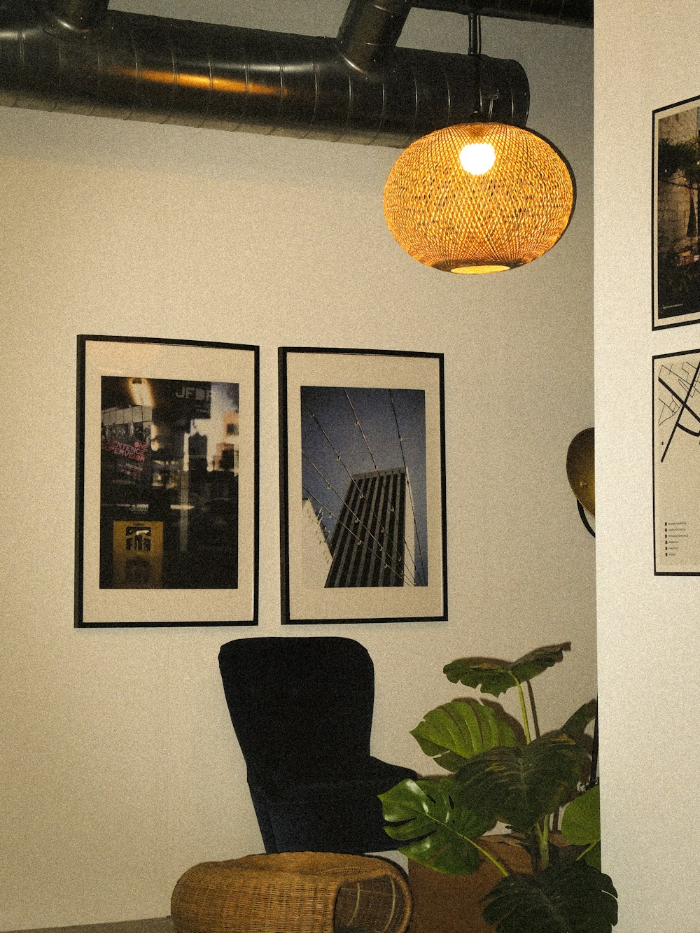 a living room with a chair and pictures on the wall