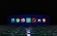 A row of browser and application icons is displayed against a dark background with a futuristic, illuminated floor. Each icon is distinct and represents a different software or web browser.