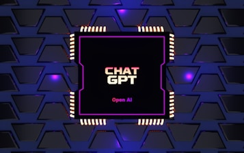 A digital rendering of an electronic circuit board, with a central black chip featuring the text 'CHAT GPT' and 'Open AI' in gradient colors. The background consists of a pattern of interconnected triangular plates, illuminated with a blue and purple glow, adding a futuristic feel.