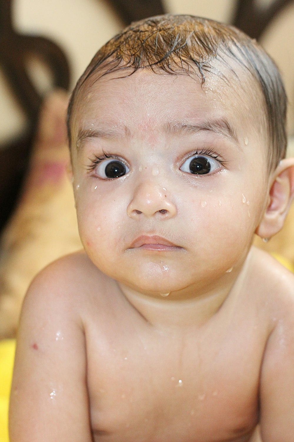 a close up of a baby with a wet face
