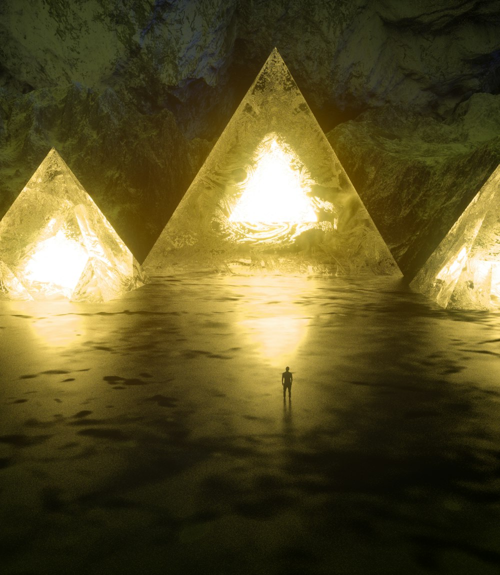 a man standing in front of a group of glowing pyramids