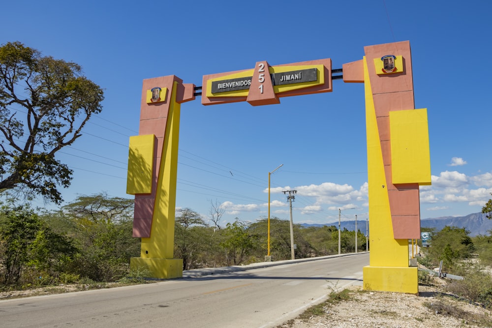 a yellow and red arch with a sign on it