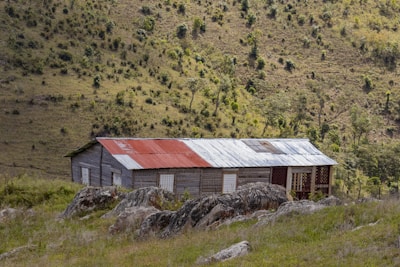 an old run down building in the middle of a field