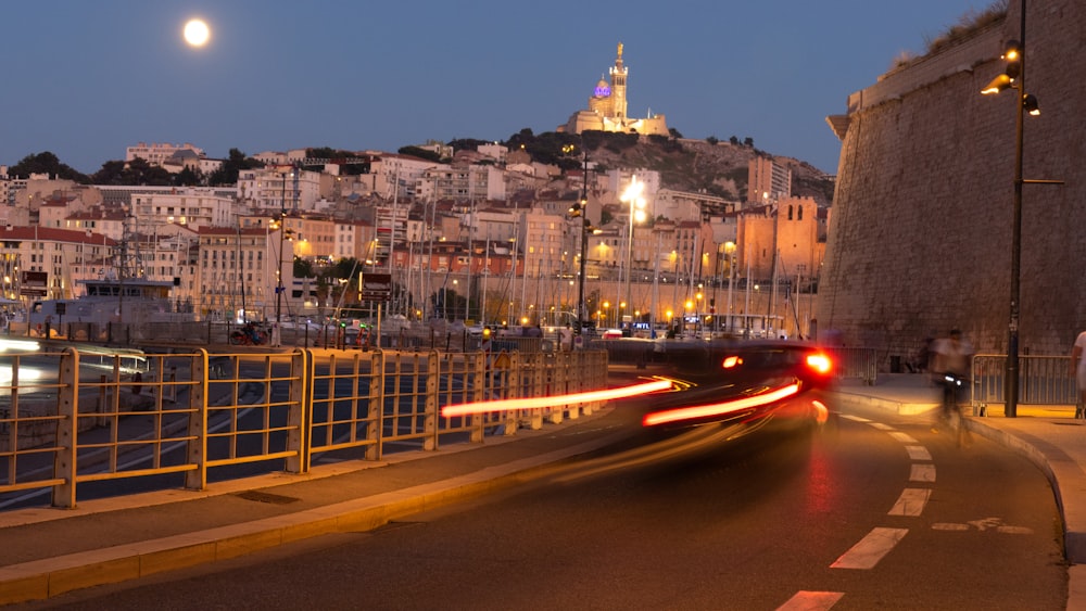 a city street with a hill in the background