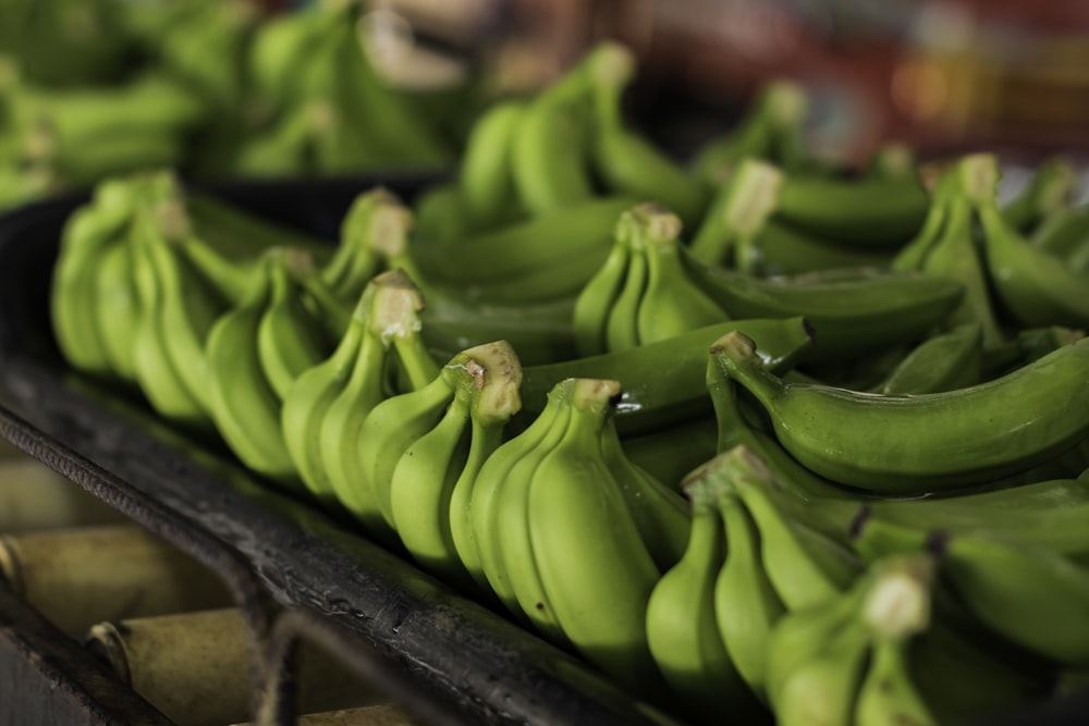 a bunch of green bananas sitting on top of a table