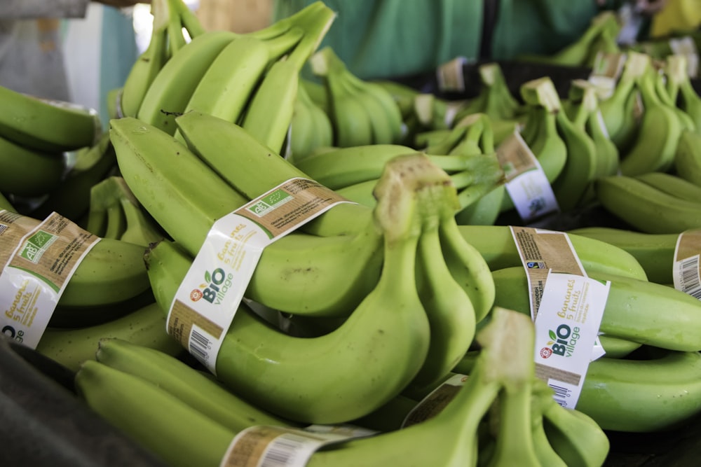 a bunch of green bananas sitting on top of a table