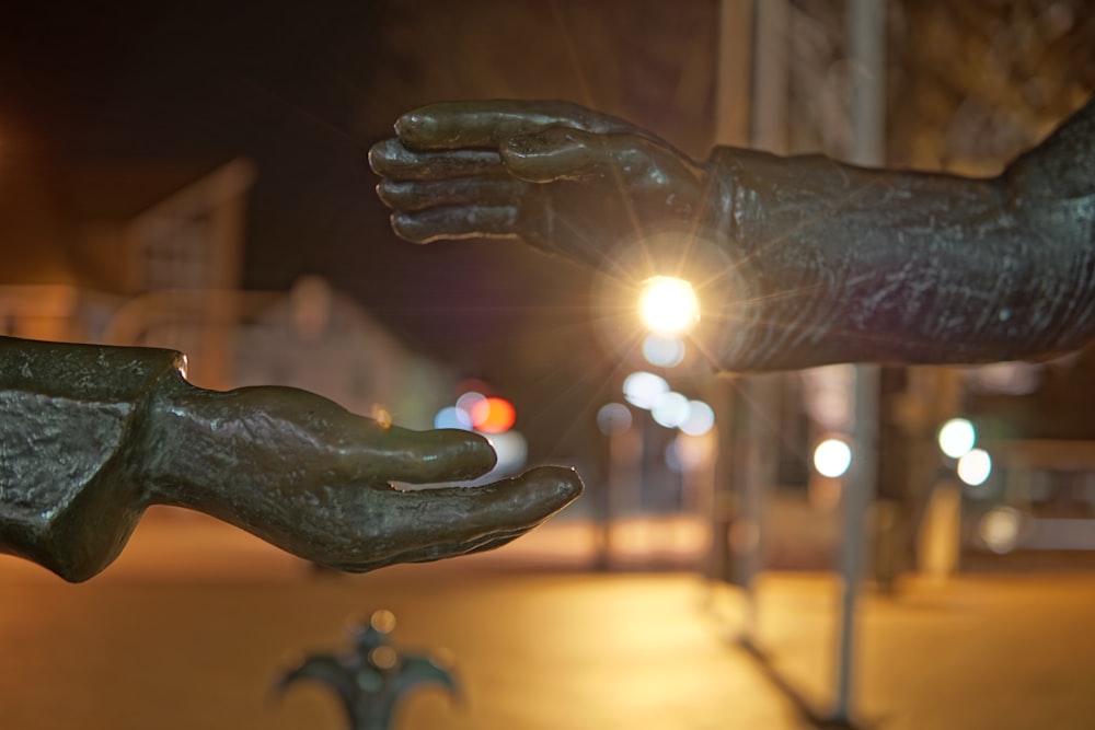 a statue of two hands reaching out towards each other