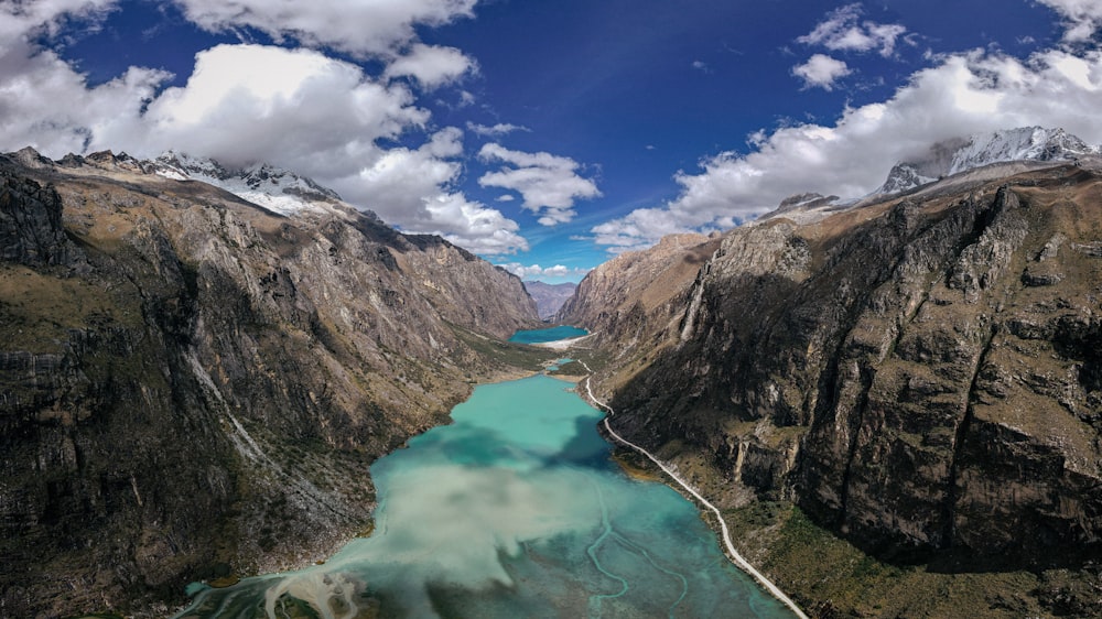 an aerial view of a mountain lake surrounded by mountains