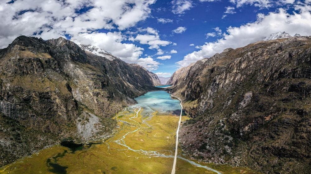 an aerial view of a river surrounded by mountains