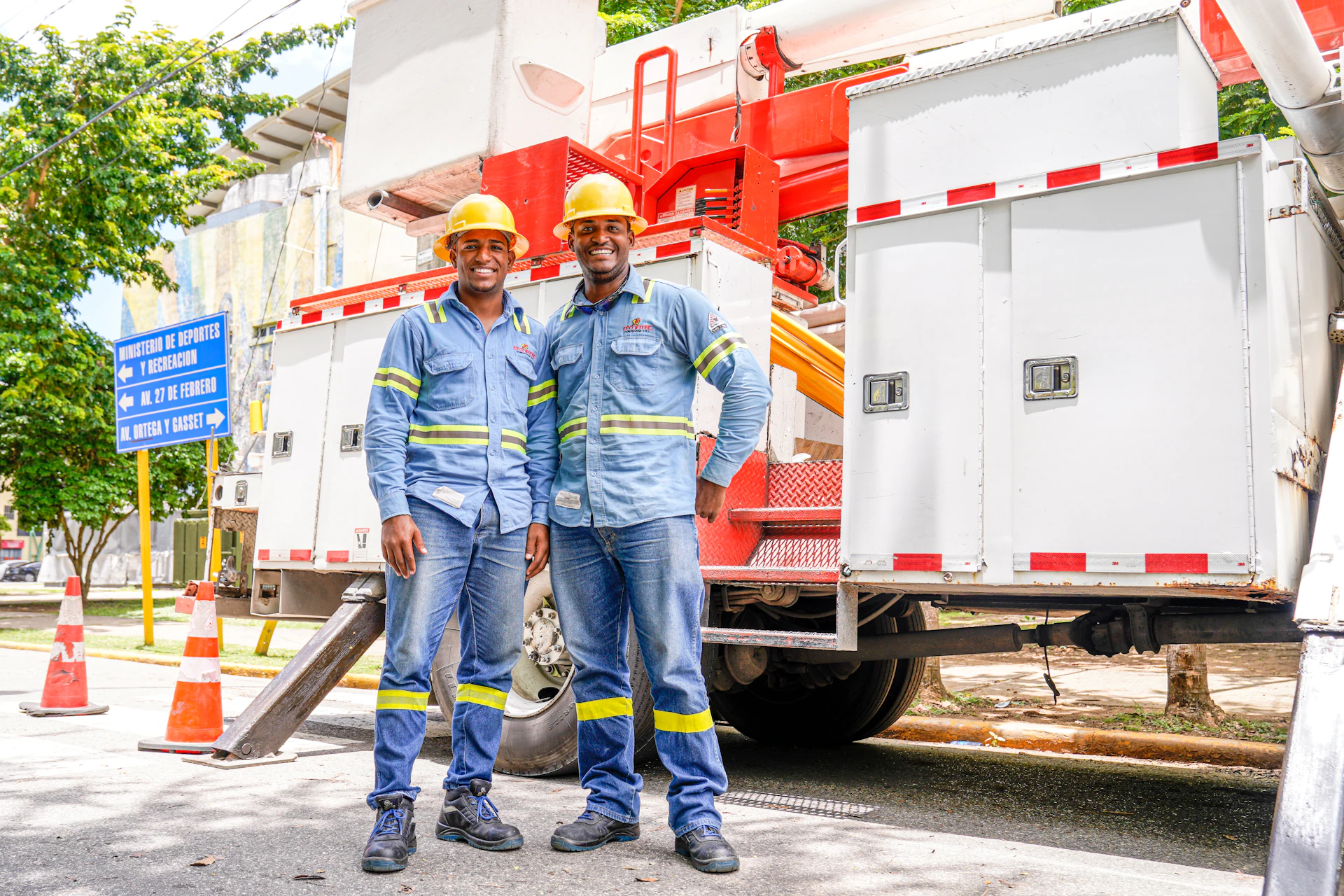 a couple of men standing next to each other in front of a truck
