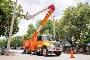 a utility truck with a crane on the back of it