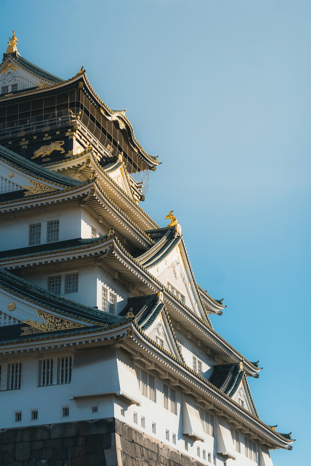 a tall white building with a sky in the background