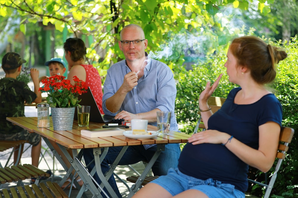 a man and a woman sitting at a table talking