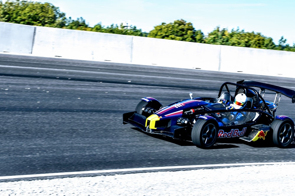 a person driving a race car on a race track