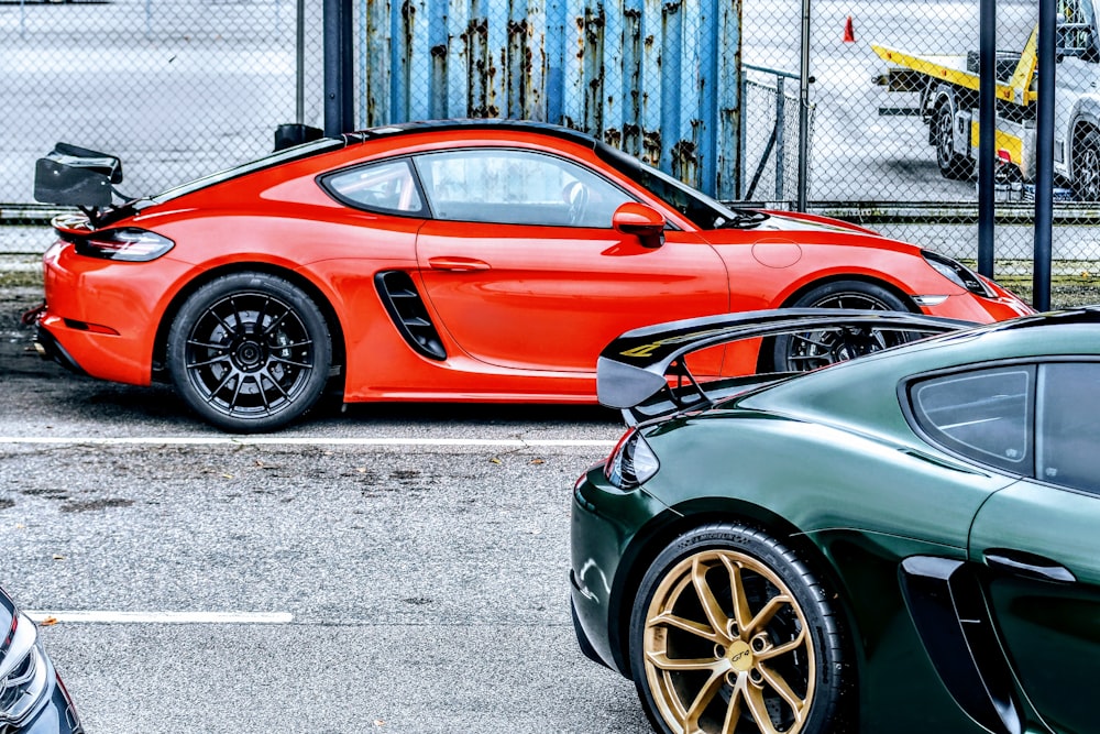 a red sports car parked next to a green sports car
