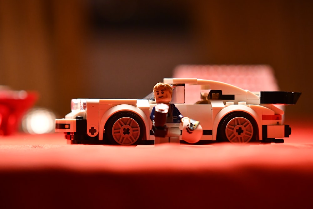 a toy car with a man sitting in the driver's seat