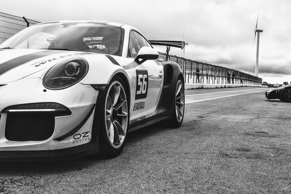 a black and white photo of a race car