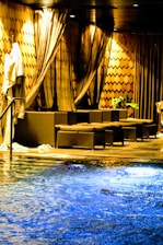 Elegant spa area featuring a warm indoor pool and relaxing lounge chairs.