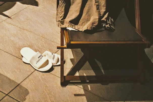 Slipara slippers drying on a towel rack, sunlight streaming through a bathroom window.