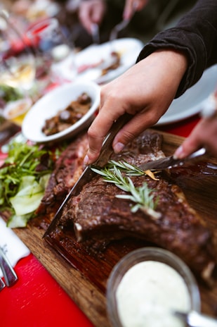 A chef slicing freshly cooked steak, ready to serve.