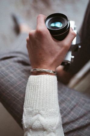 a person holding a camera in their hand