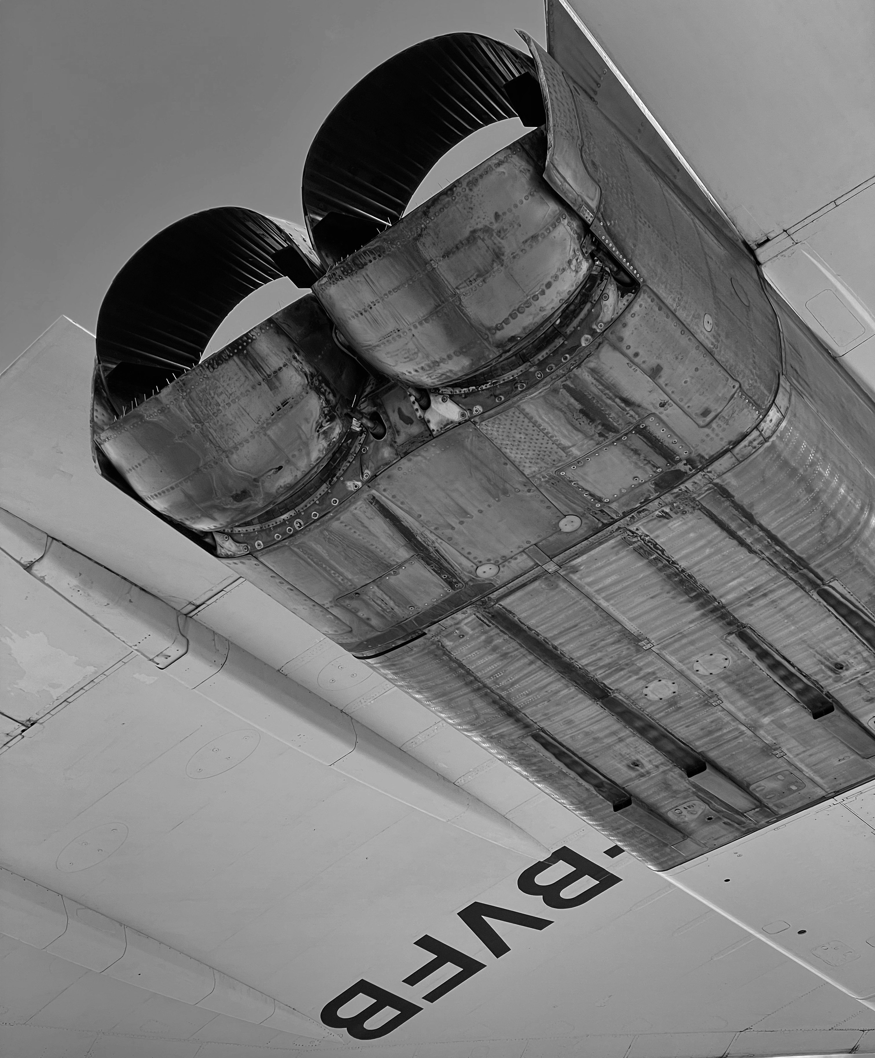 a black and white photo of the tail end of an airplane