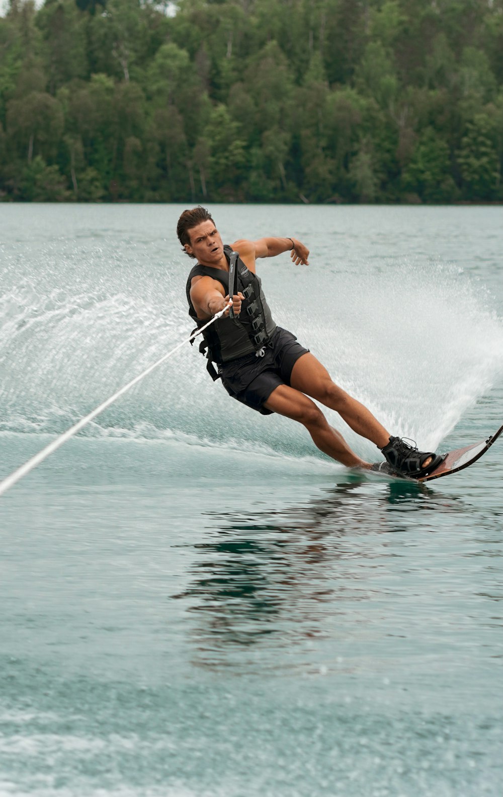 a man riding a wake board on top of a lake