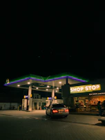 Nighttime exterior shot of adiid pro limited petrol station illuminated under the stars.