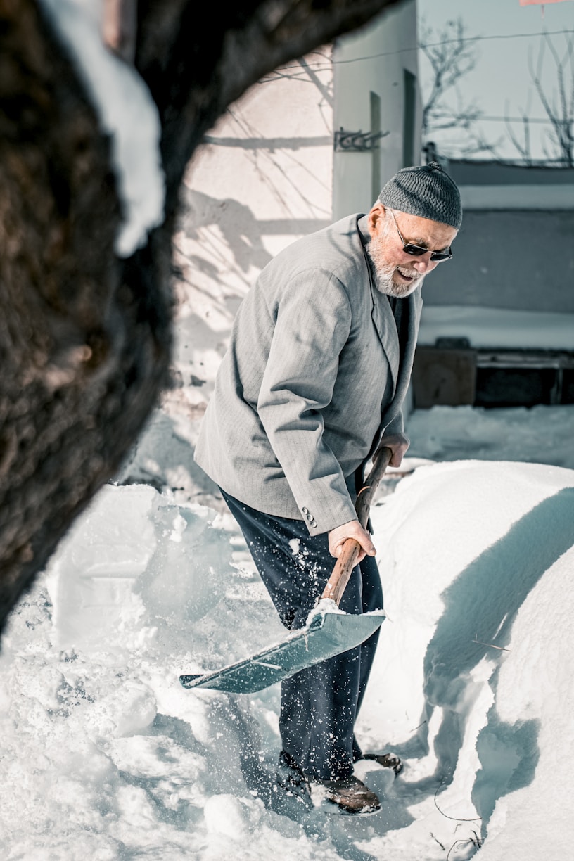 a man shoveling snow with a shovel