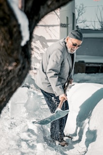 a man shoveling snow with a shovel