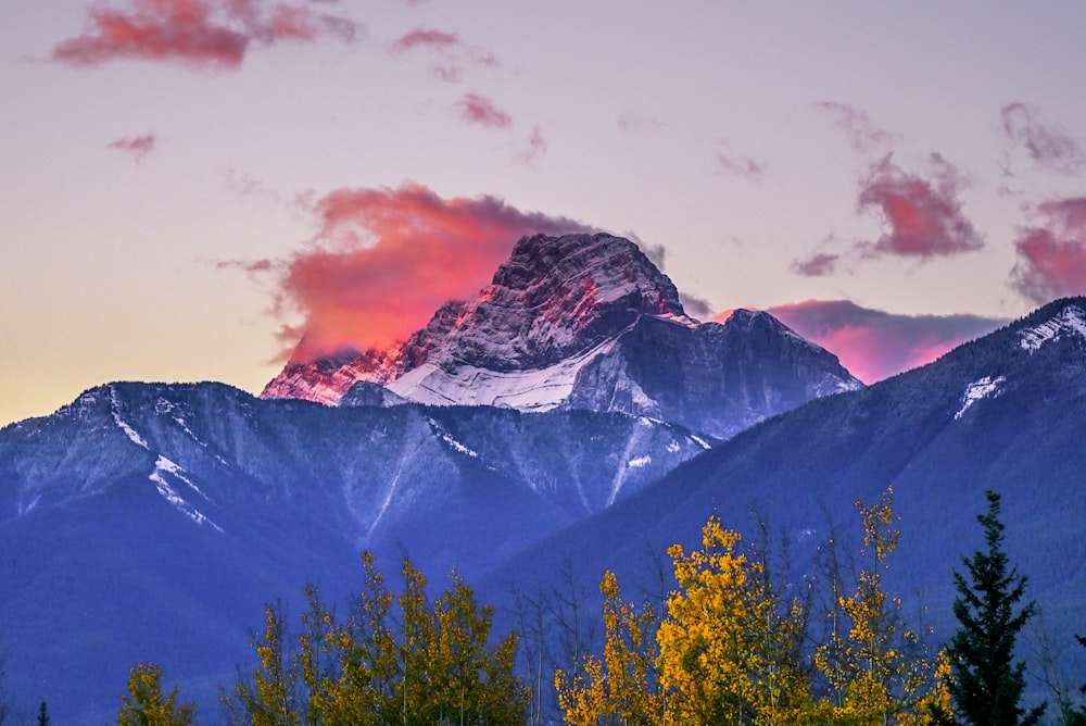 a mountain range with a pink sky in the background