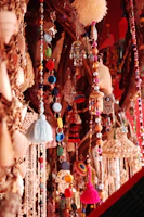 Vibrant collection of artisan charms from around the world displayed on colorful fabric.