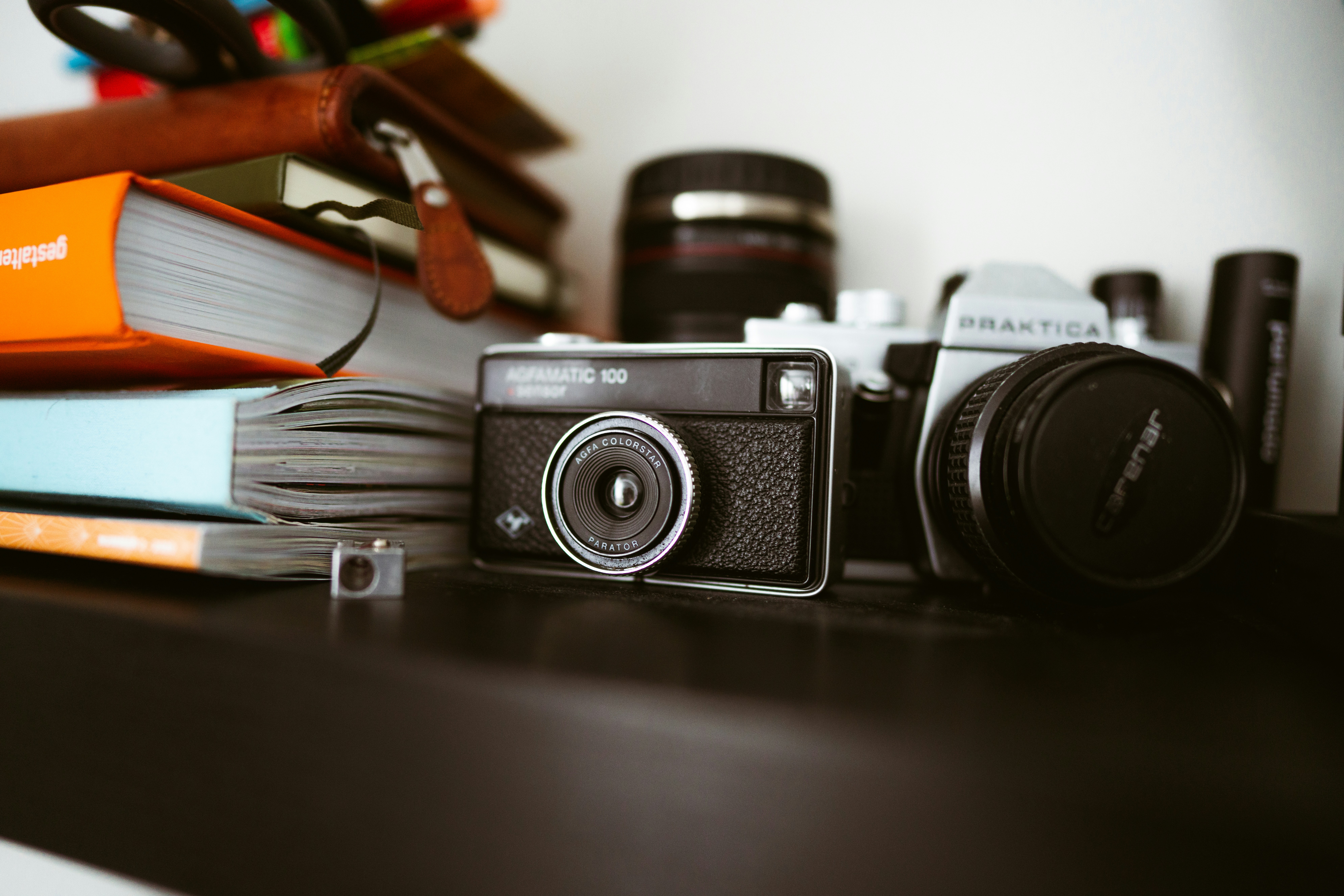 a camera sitting on top of a table next to books