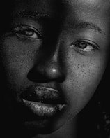 Elegant black and white headshot emphasizing texture and detail in the face.