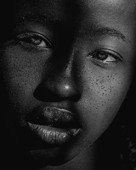 A close-up of a vintage tintype portrait showing delicate silver details and subtle textures.