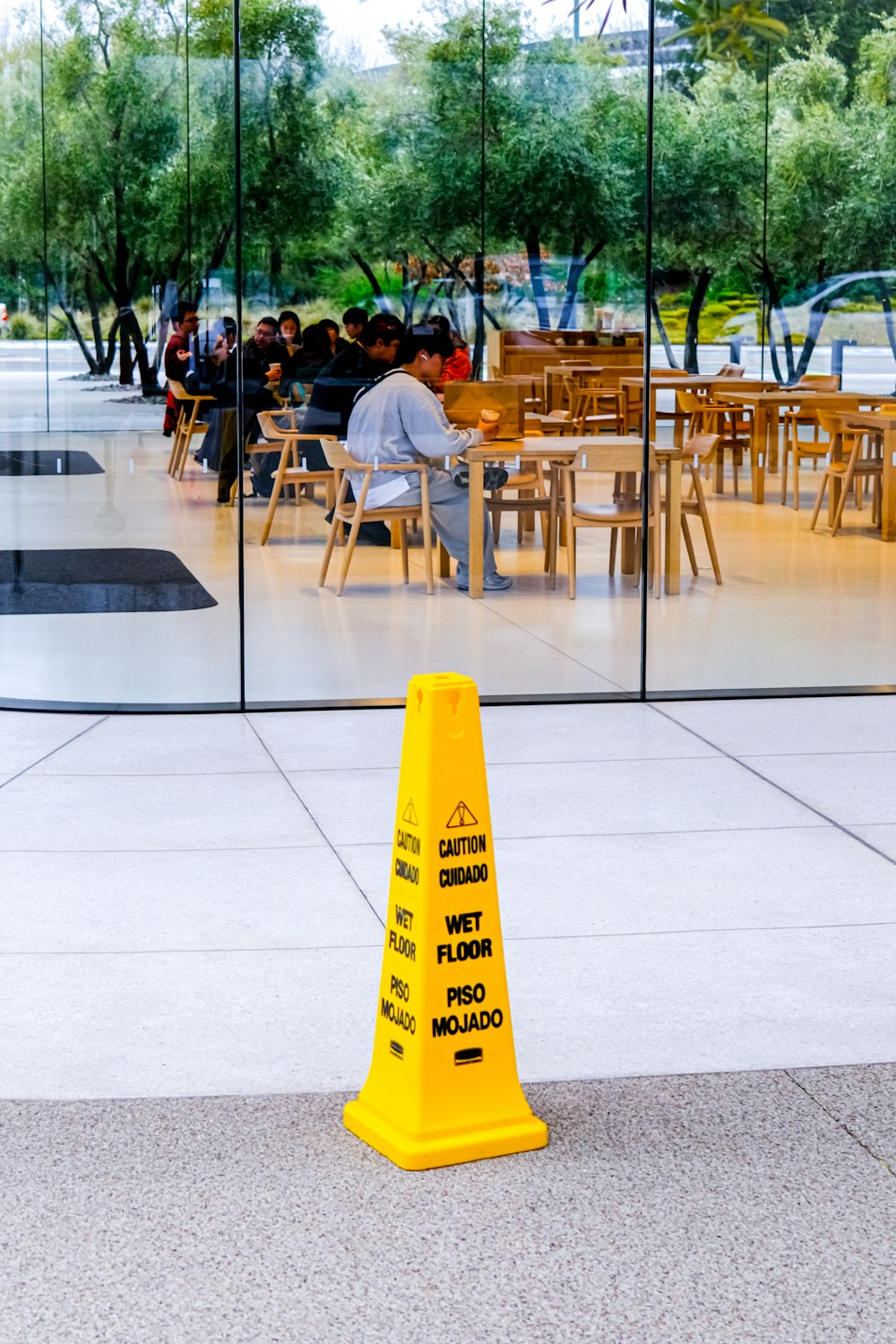 a yellow cone sitting in front of a glass wall