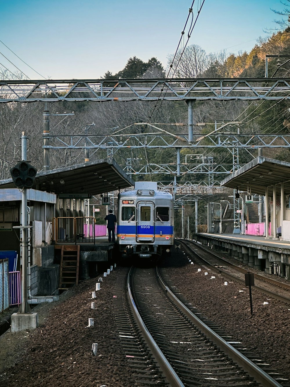 a train traveling down train tracks next to a train station