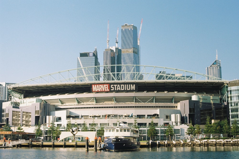 a boat is docked in front of a stadium