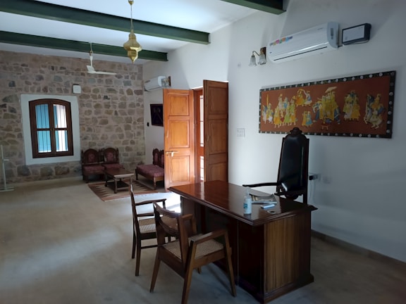 Stylish office with artistic stone wall that divides the room subtly.