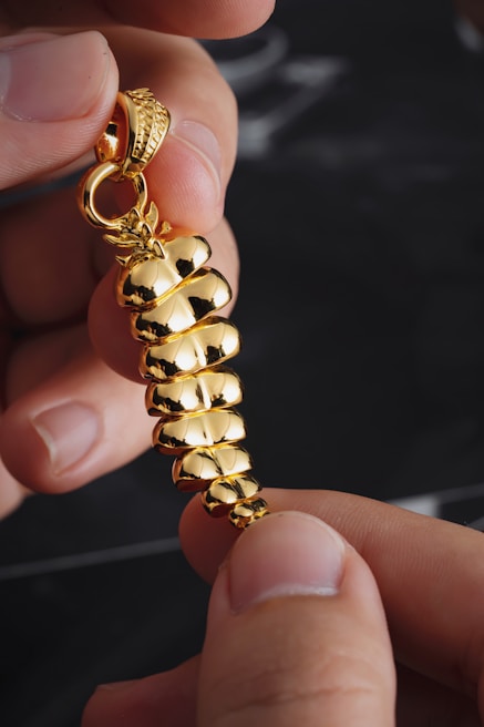 Close-up of hands holding a quartz crystal pendant catching the morning light