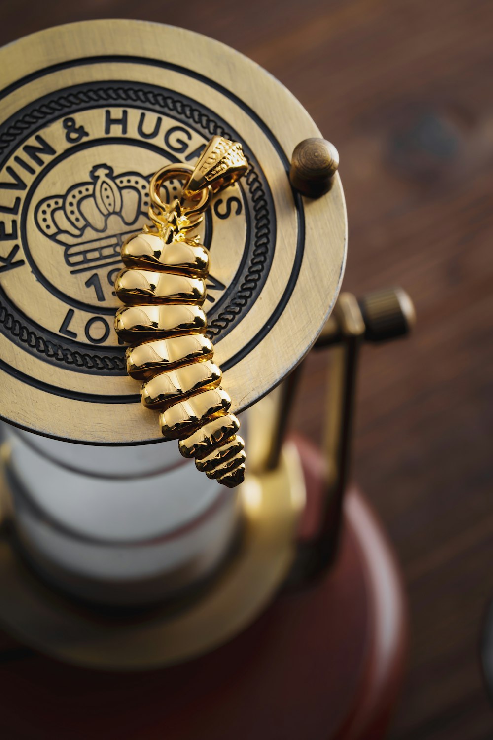 a close up of a coffee pot with a gold sea horse on it