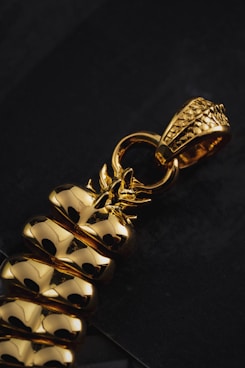 a close up of a metal object on a black surface