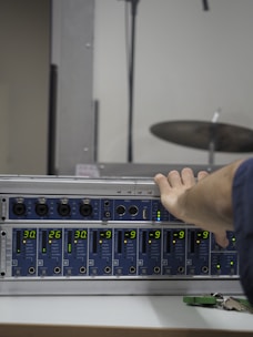Close-up of sound engineers adjusting the array speakers during a live event setup.