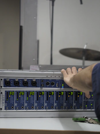 Acoustic tuning lab with engineers adjusting sound curves on high-end audio equipment.