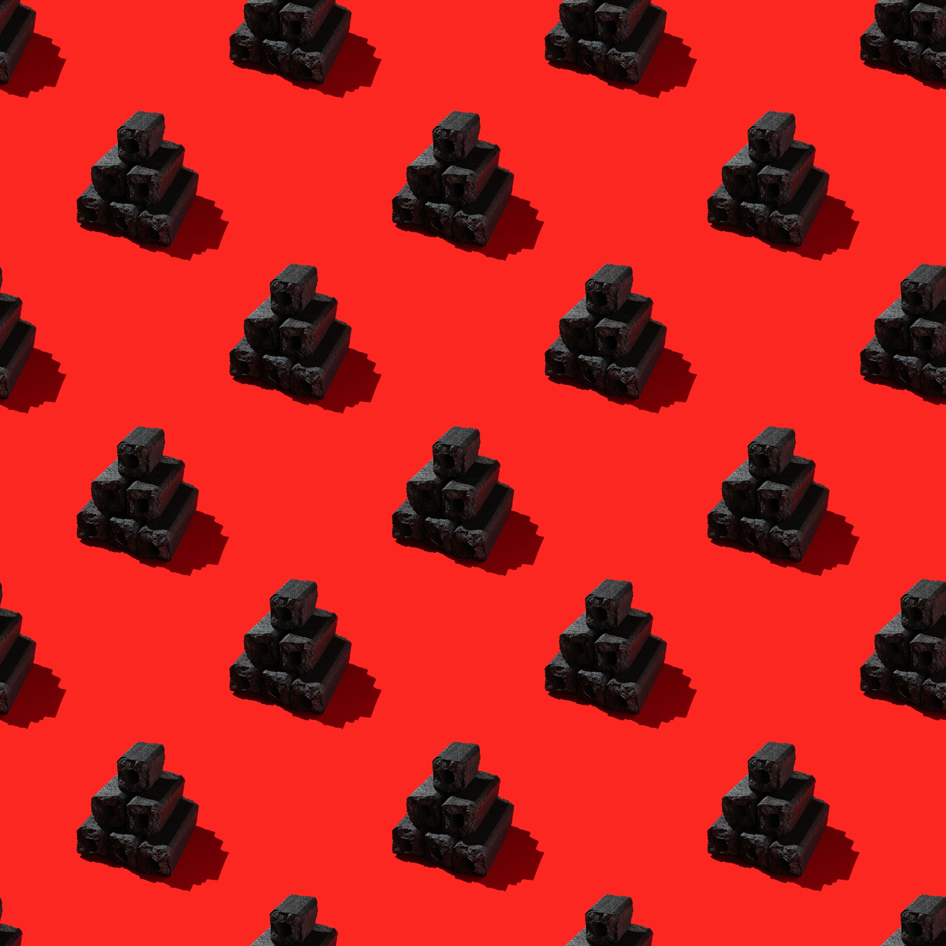 a red background with a pattern of black cubes