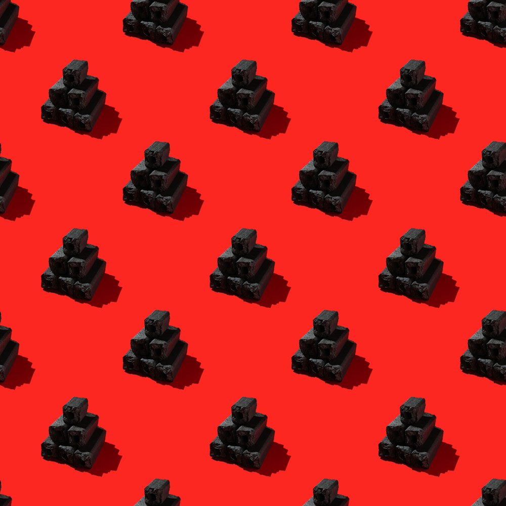 a red background with a pattern of black cubes