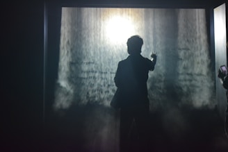 An elegant water screen hologram casting ethereal images above a nighttime event pool.