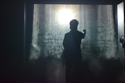 An elegant water screen hologram casting ethereal images above a nighttime event pool.