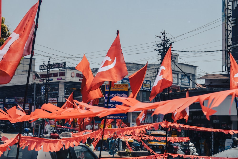 many orange flags are flying in the air