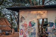 Artists painting colorful murals inspired by nature and sustainability inside the event space.